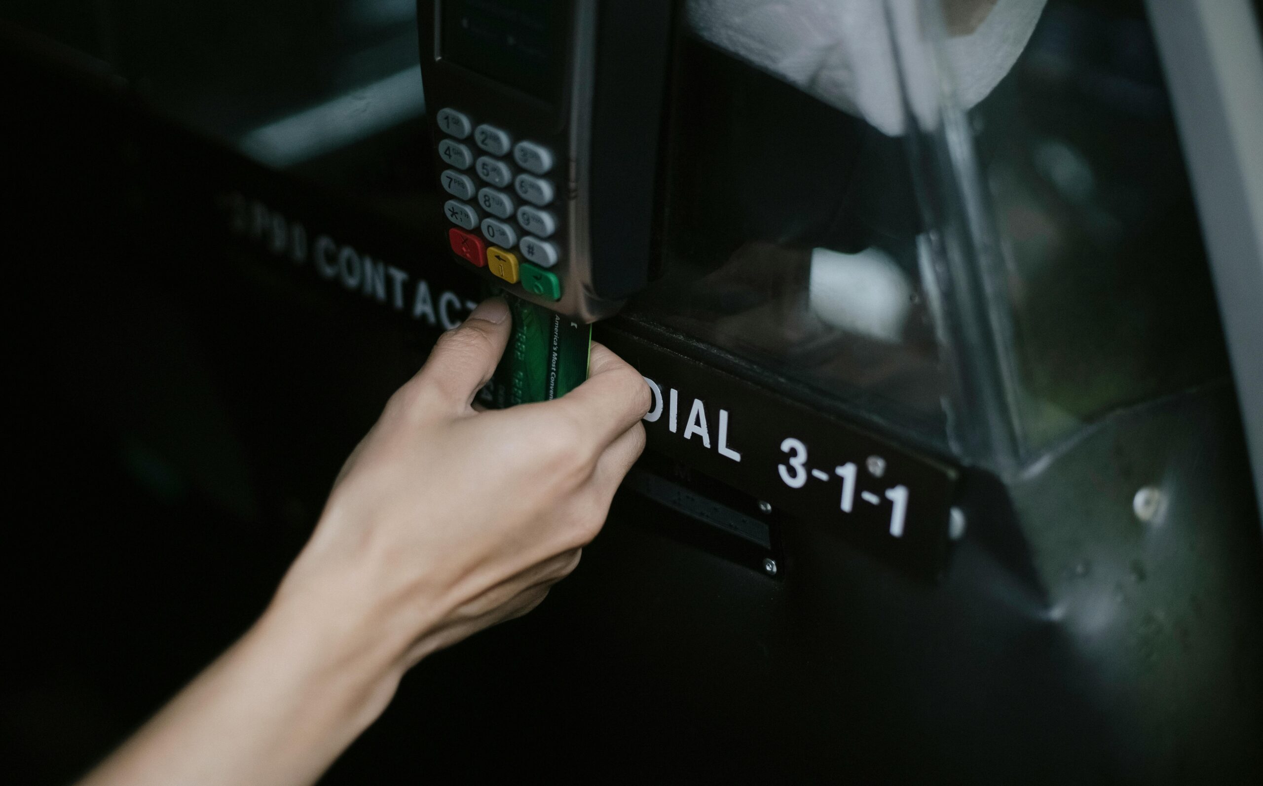 Metal credit card placed next to traditional plastic card highlighting weight difference