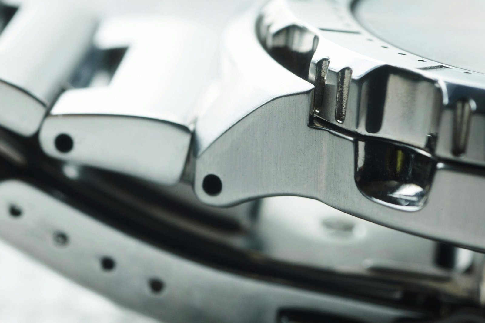 A sleek metal credit card placed elegantly next to a passport and luxury watch