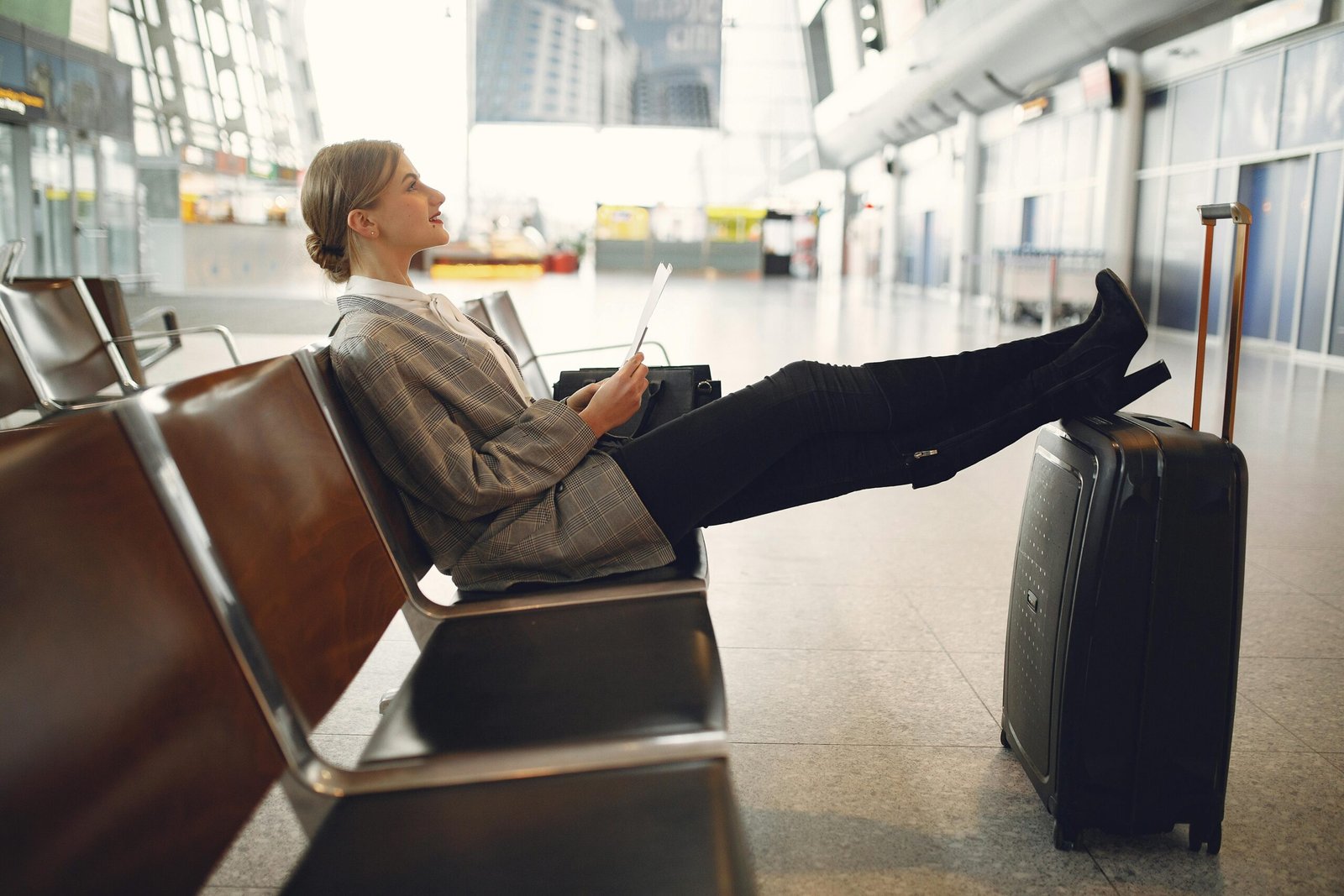 Happy traveler relaxing in airport lounge chair