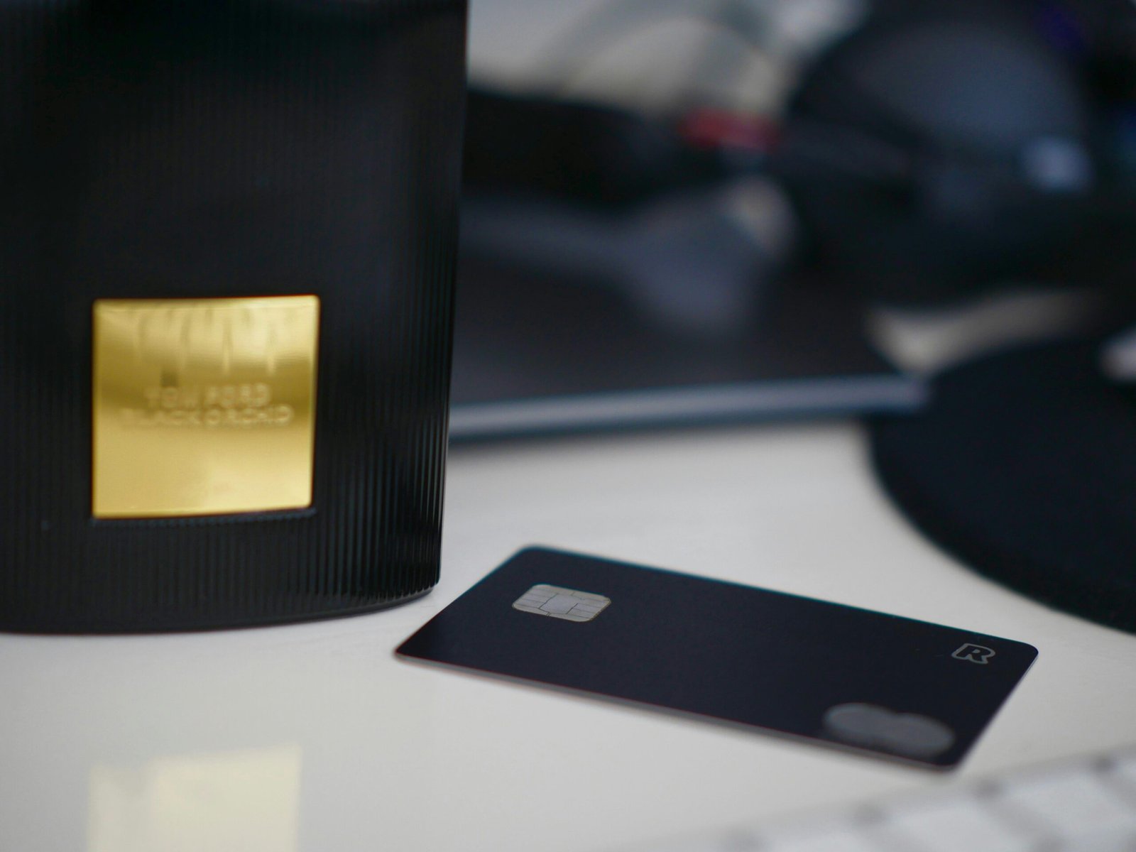 A sleek black metal credit card resting on a marble surface