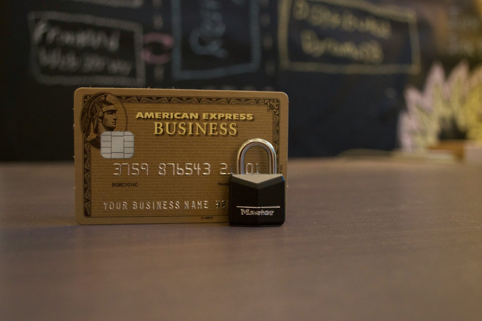 A sleek metal credit card resting on a wooden table