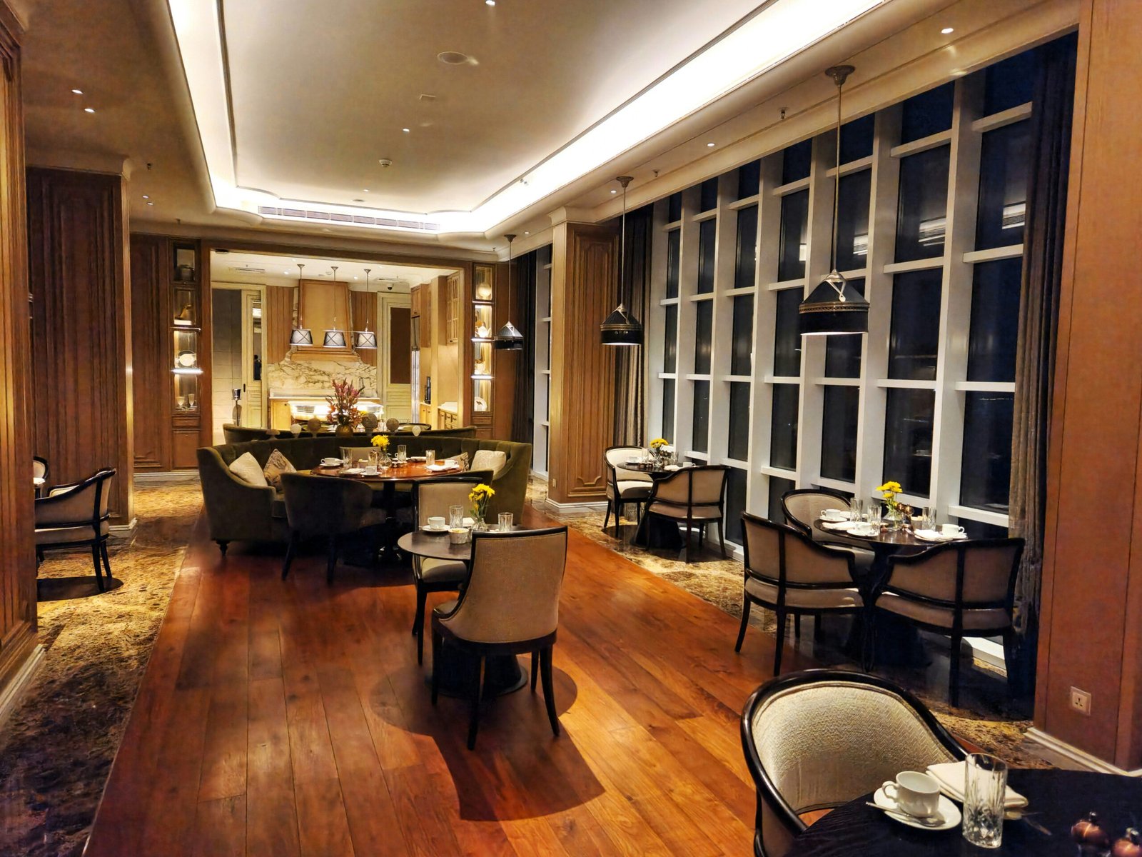 An elegantly set dining table with candles and wine glasses