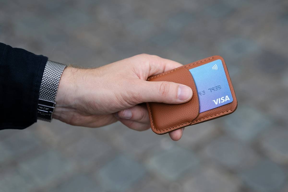 An open RFID-blocking wallet with slots for multiple cards, including a metal credit card.