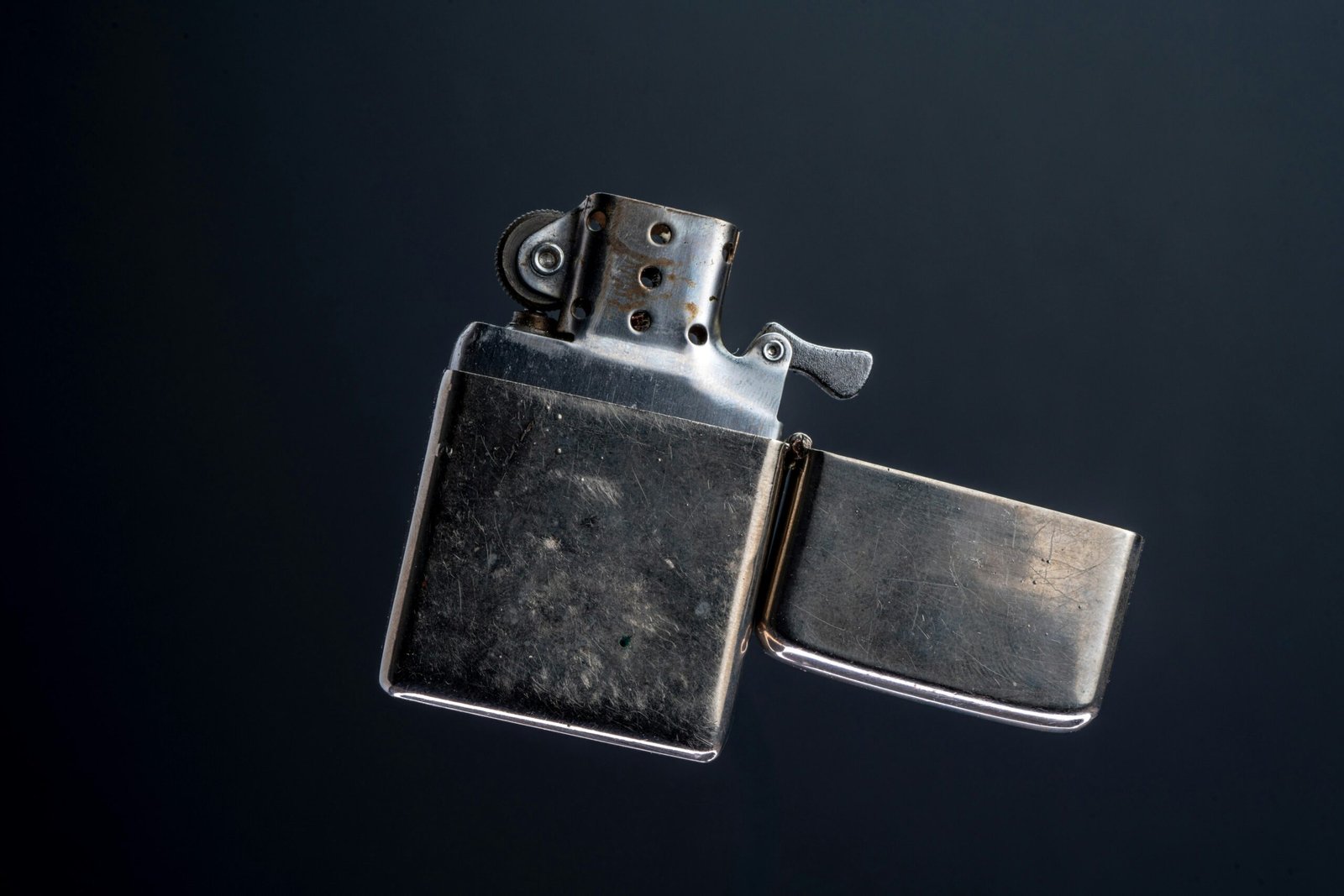 A lighter is shown in the air with a black background